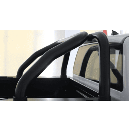 Black tubular roll bar installed in the bed of a silver pickup truck.