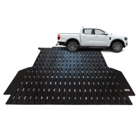 White pickup truck positioned on a large black metal ramp/platform for vehicle lifting or maintenance.