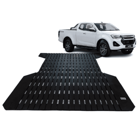 White pickup truck at the end of a long black grated car loading ramp, ready to drive onto a trailer or elevated platform.