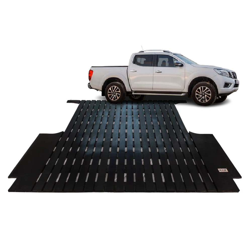 White pickup truck on a black metal vehicle ramp used for loading cars or onto a trailer.