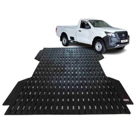 White pickup truck on a large black slatted vehicle ramp/loader platform.