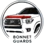 Circular logo featuring a car steering wheel and dashboard inside a gray ring, with small text beneath the image.